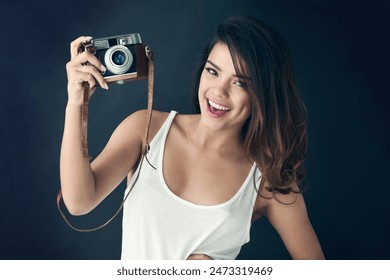 Photographer, woman and studio for creative person, photography for memories on blue background. Portrait, vintage equipment and photo journalist or paparazzi, smile and professional with camera - Powered by Shutterstock