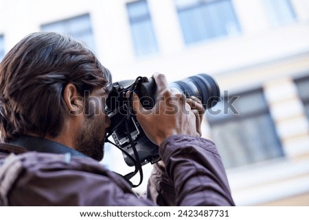 Photographer, work and man in city for travel, journey and filming memory of adventure with camera. Professional, cameraman and person capture creative photography with lens outdoor in photoshoot