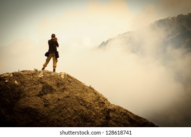 Photographer at the work in the mountains - Shutterstock ID 128618741