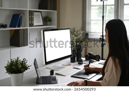Photographer working in a creative studio with camera gear on the desk