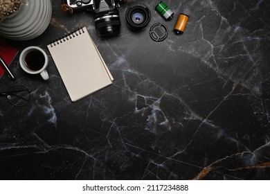 Photographer workplace with retro camera, notebook and coffee cup on marble background. - Powered by Shutterstock