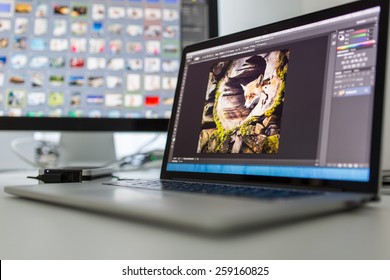 Photographers computer with photo edit apps/programs running 