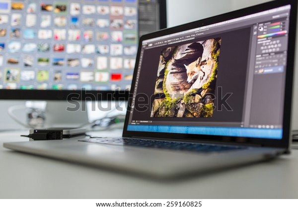 Photographers computer with photo edit apps/programs\
running 