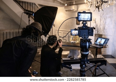 Photographers and models shooting in a studio