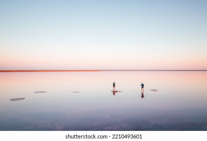 Photographers Take Photos On A Salt Lake At Sunrise. Location Place Of Syvash Lake, Kherson Region, Ukraine, Europe. Fantastic Photo Wallpaper. Image Of Exotic Places. Discover The Beauty Of Earth.