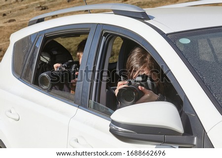 Photographers taking pictures in Iceland sitting in a car