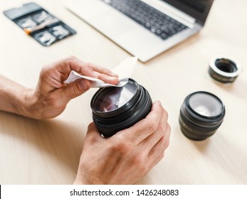 Photographing Equipment Care Service. Cropped Shot Of Technician Cleaning Camera Lens With Wet Wipe.