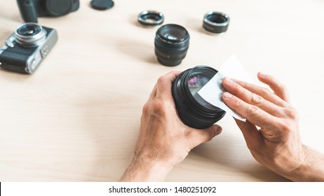 Photographing Equipment Care Service. Technician Cleaning Camera Lens With Wet Wipe.