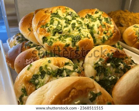 Photographing freshly baked spring onion bread in a bakery