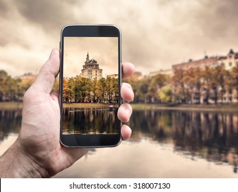 Photographing with smartphone in hand. Travel concept. Moscow cityscape, Patriarch Ponds