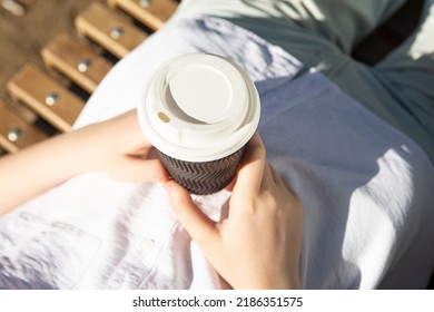 Photography From Above Of Anonymous Woman, Holding Craft Paper Cup With Coffee Outside.