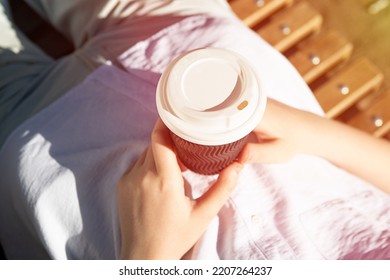 Photography From Above Of Anonymous Woman, Holding Craft Paper Cup With Coffee Outside,sunlight On Background.