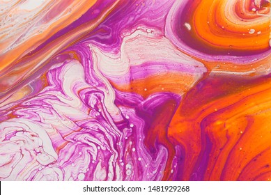 photography of abstract marbleized effect background. red, pink, orange and white creative colors. Beautiful paint