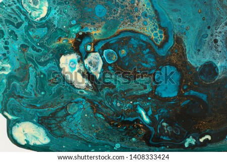 photography of abstract marbleized effect background. Blue creative colors. Beautiful paint with the addition of gold