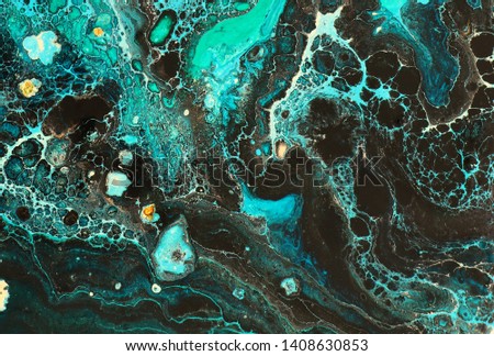 photography of abstract marbleized effect background. Blue creative colors. Beautiful paint with the addition of gold