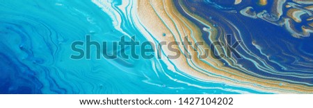 photography of abstract marbleized effect background. gold, blue and white creative colors. Beautiful paint. banner