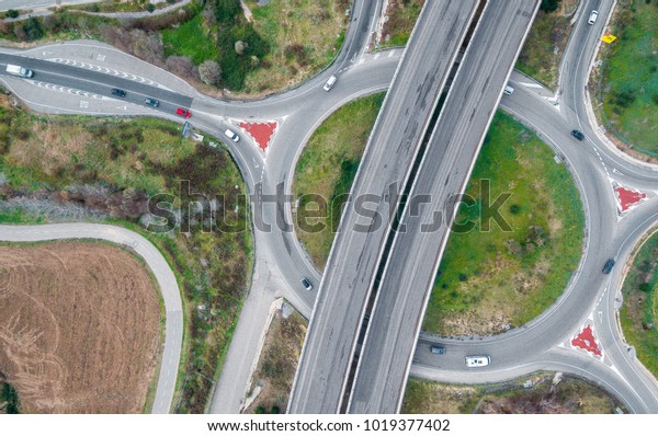 Photography aerial of a highways with little traffic\
on a cloudy day