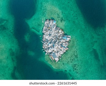 Photography from the air made on a mavic air drone on a sunny day with turquoise water. The most populated island in the world is called Santa Cruz del Islote, which is located in the San Bernardo arc