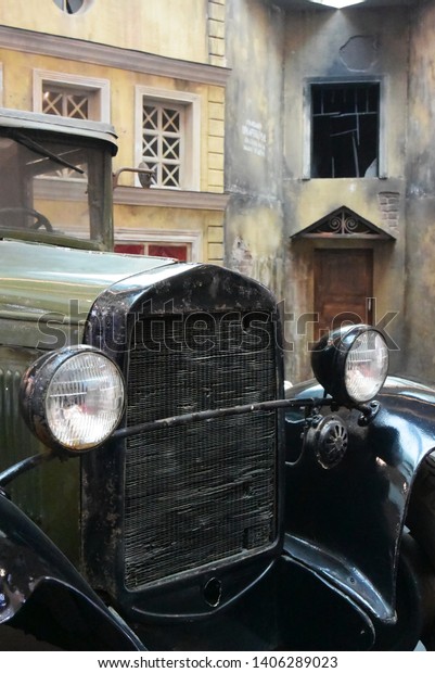 Photography background with a retro car on the\
background of a destroyed\
house\
