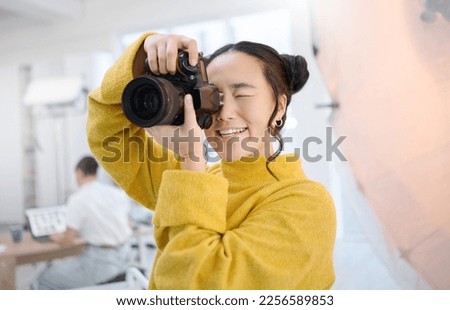 Photography, camera and photographer in studio shooting creative memory picture, Japanese photoshoot or digital production. Lens focus, art creativity and young Asian woman working for artistic shot