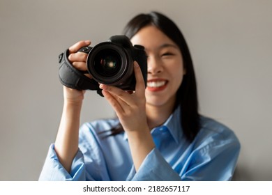 Photography Career. Happy Asian Woman Holding Camera Smiling To Camera Taking Photo Standing Indoors. Female Photographer Posing With Photocamera. Creative Hobby Concept - Powered by Shutterstock