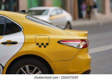 Photography of city taxi on the motorway in summer day. Image with defocused background. Suitable for posters, greeting card. Close up image