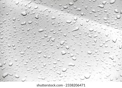 a photography of a close up of a rain covered window, a close up of a rain covered window with water droplets. - Powered by Shutterstock