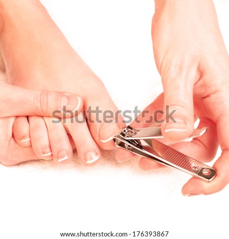 Photography closeup of a woman cutting toenails