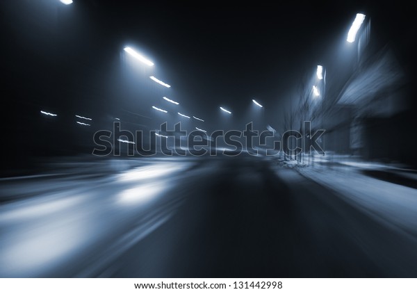 Photography during a night drive in\
black and white. Blurred by the speed and light/Night\
drive