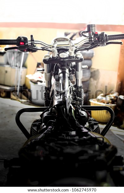 Photography of  front motorcycle ,fuel line and\
wiring under the the fuel\
tank.