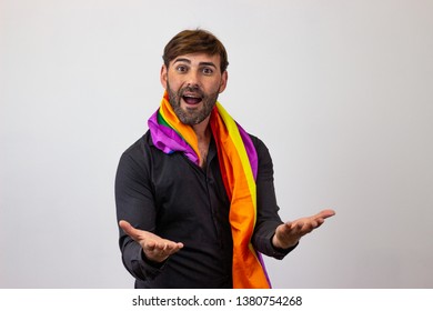 Photography Of A Handsome Young Man With Gay Pride Movement LGBT Rainbow Flag Holding Up Three Fingers, Their Back Facing The Camera And Looking At The Camera