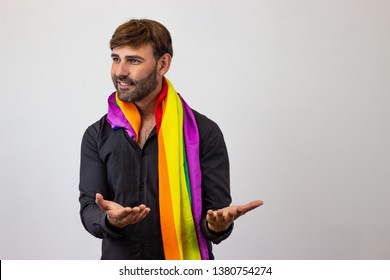 Photography Of A Handsome Young Man With Gay Pride Movement LGBT Rainbow Flag Holding Up Three Fingers, Facing Forwards And Looking At The Horizon