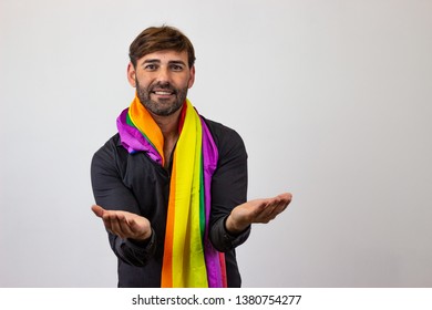 Photography Of A Handsome Young Man With Gay Pride Movement LGBT Rainbow Flag Holding Up Three Fingers, Looking At The Camera