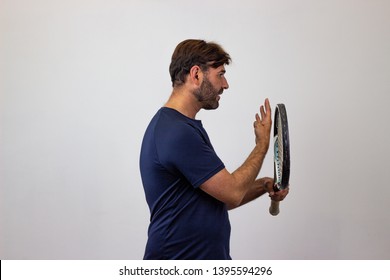 Photography Of A Handsome Young Man Playing Tennis Holding Up Six Fingers, Facing Forwards And Looking At The Side