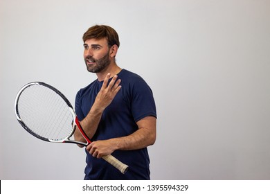 Photography Of A Handsome Young Man Playing Tennis Holding Up Six Fingers, Facing Forwards And Looking At The Horizon