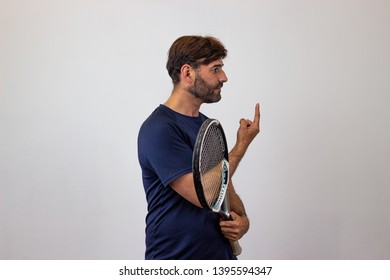 Photography Of A Handsome Young Man Playing Tennis Holding Up Three Fingers, Facing Forwards And Looking At The Side