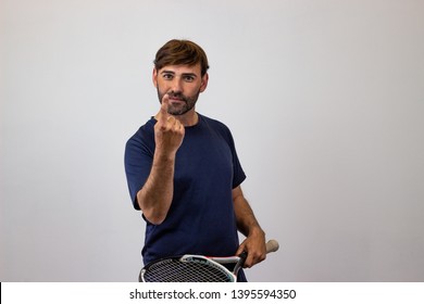 Photography Of A Handsome Young Man Playing Tennis Holding Up Three Fingers, Looking At The Camera