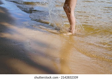 Photography Of Human Feet. One Person Walking On The Sandy Beach. Vacations Concept. Close Up Photography