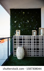 Photography Of Inner City Apartment Balcony Garden Decor With Astro Turf Floor, A Garden Wall, Hurricane Lamps On Wall Display