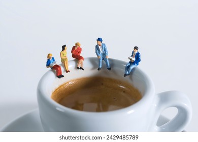 Photography of miniature people and toy figures, a group of people sits on a coffee cup for a break, close up
​ - Powered by Shutterstock