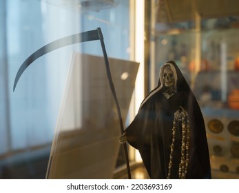 Photography of mock-up of Death with a scythe indoor. Symbol of death and halloween party. Conceptual image. Frontal view - Shutterstock ID 2203693169