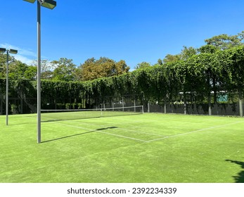 Photography of a nice outdoor tennis court with artificial grass surface - Powered by Shutterstock