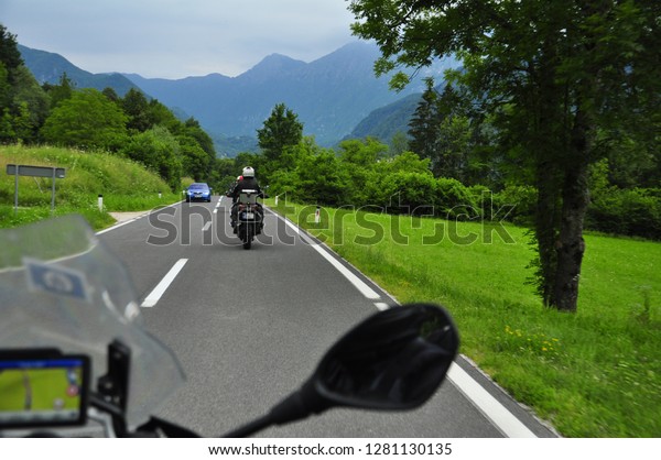 Photography on a moving\
motorcycle - bikers bike riding travelling in formation trough\
Slovenia, beautiful landscapes, adventure motorcycles, summer time,\
mountain background