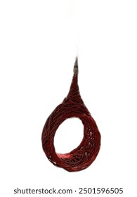 a photography of a pair of scissors hanging from a string.