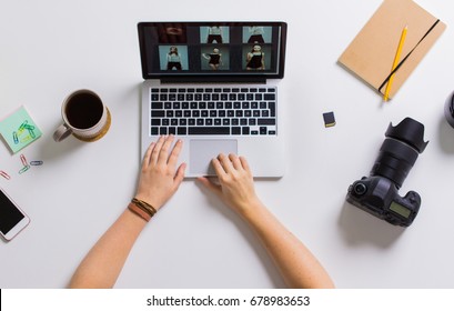 photography, people and technology concept - hands of photographer with camera reviewing model photoshoot on laptop computer screen at table - Powered by Shutterstock