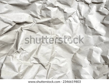 a photography of a piece of crumpled paper with a black background, wrinkled paper with a black background and a white background.