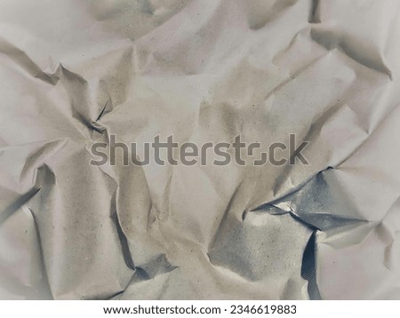 a photography of a piece of paper with a piece of scissors on it, there is a piece of paper that has been torn off.