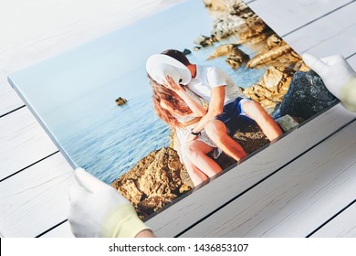 Photography printed on canvas with gallery wrap method of canvas stretching. Photo of kissing couple in love is in male hands