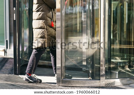 Photography of revolving office door entrance of modern business center. Manager coming. Business concepts and lifestyles.