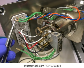 A Photography Showing An Opened Mass Spectrometer And An Ion Source Assembly. Selected Focus.